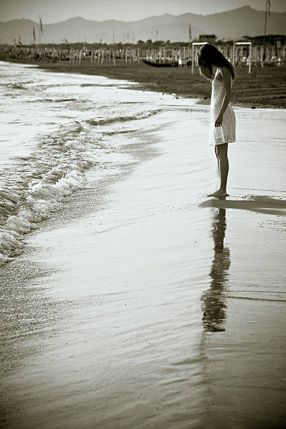 istock Girl on beach at dusk 180747652
