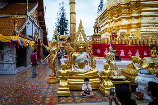 Japanese tourists take photos with a mobile phone at Wat Phra That Doi Suthep, a temple at Doi Suthep in Chiang Mai, Thailand.