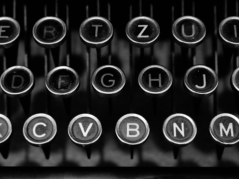 A black and white shot of an antique typewriter's keyboard.