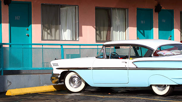 istock Retro blue and white car parked in front of a hotel 180748721