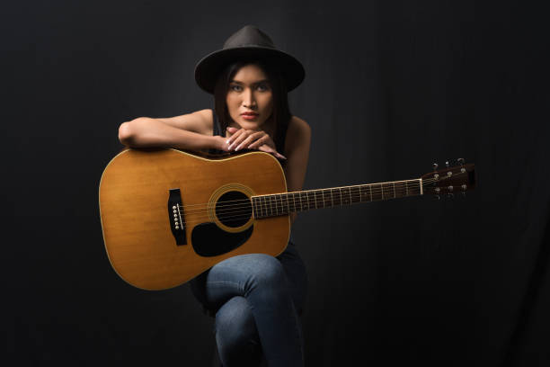 istock Guitarist poised with her instrument 1807488781