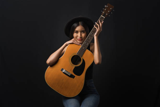 istock Guitarist poised with her instrument 1807488782