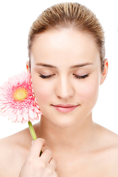 istock Beautiful young woman with flower 180749290