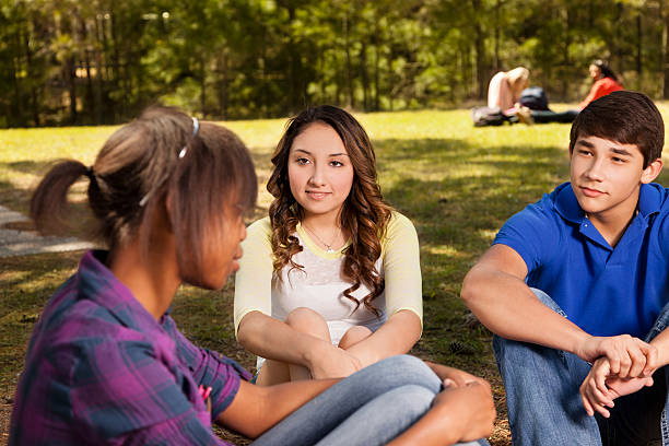 istock Teenagers:  Multi ethnic group of friends enjoying visiting in park 180749358