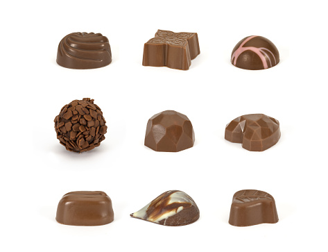 A delightful assortment of Belgian chocolates elegantly arranged on a pristine white background. Indulge in the rich, velvety textures and exquisite flavors of these Belgian delights. Perfect for moments of sweet indulgence or as a sophisticated gift for any occasion. The contrast of the chocolates against the clean white backdrop adds a touch of elegance to this tempting display.
