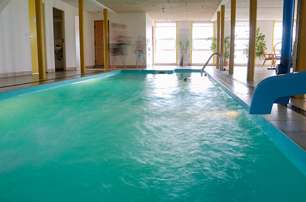 istock Indoor swimming pool with motion blurred people 180749929