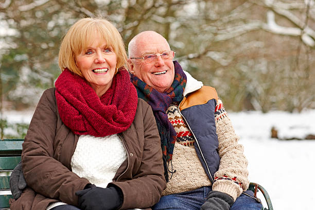 istock Happy senior couple together on bench looking away 180750119