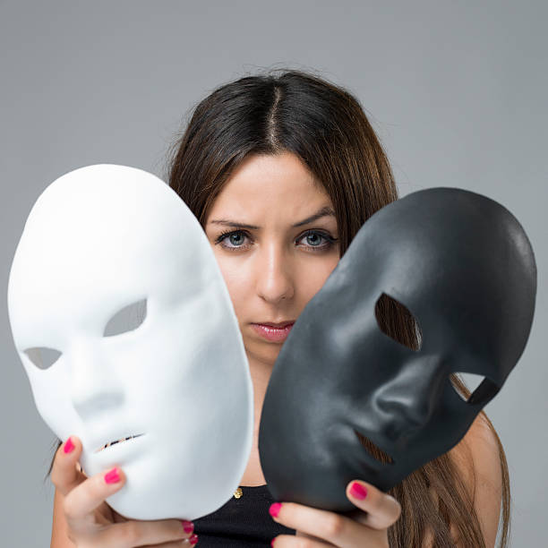 istock woman holding two drama masks. 180750145