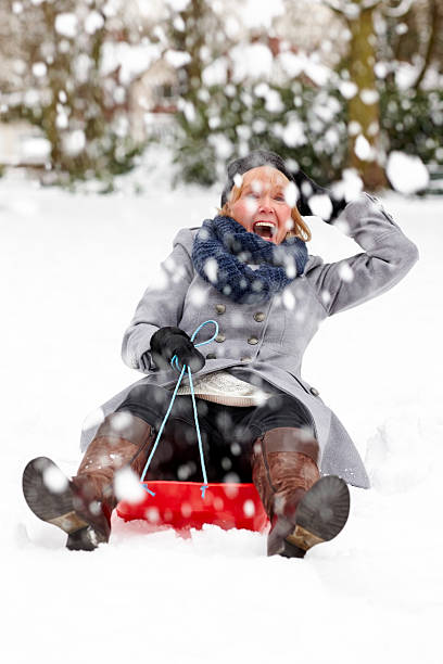 istock Senior woman on sledge having fun 180750253