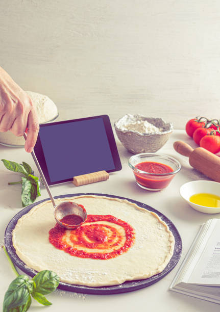 istock Raw dough for pizza with ingredient: tomato sauce 1807502657