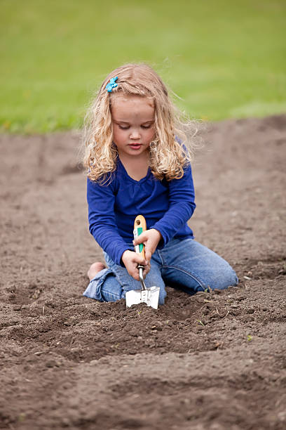 istock Girl Digging in Garden 180750333
