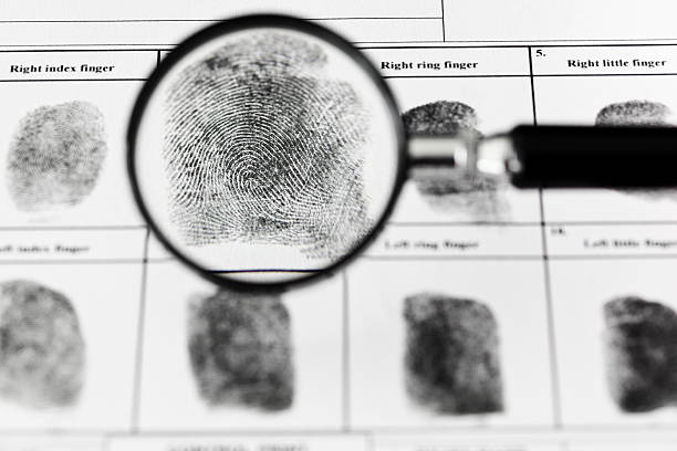 istock Fingerprints on authentic fingerprint form. Magnifying glass. 180751198