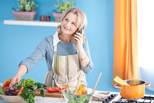 istock Senior woman cooking. 180751243
