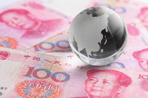 istock glass globe and china money 180751247
