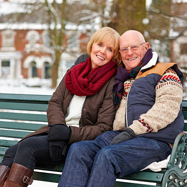 istock Pretty mature couple sitting on bench at park 180751287