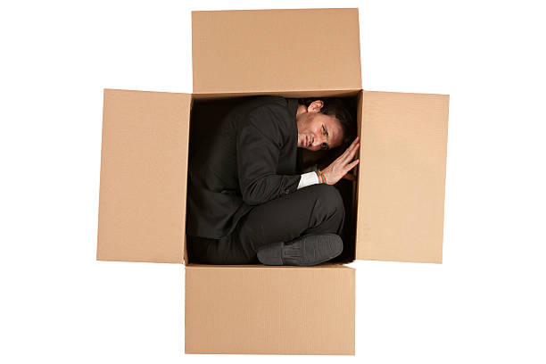 istock Businessman inside a cardboard box 180751560