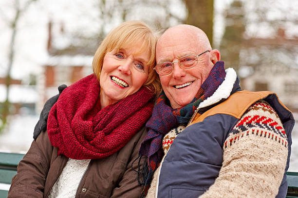 istock Romantic senior couple sitting together smiling 180751577