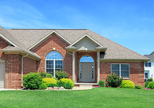 Brick Home Modern Brick home with nice landscaping and blue sky in the background. Gable stock pictures, royalty-free photos & images