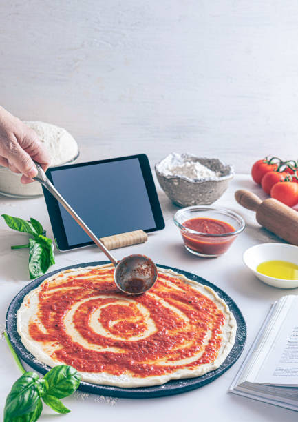 istock Raw dough for pizza with ingredient: tomato sauce 1807522854