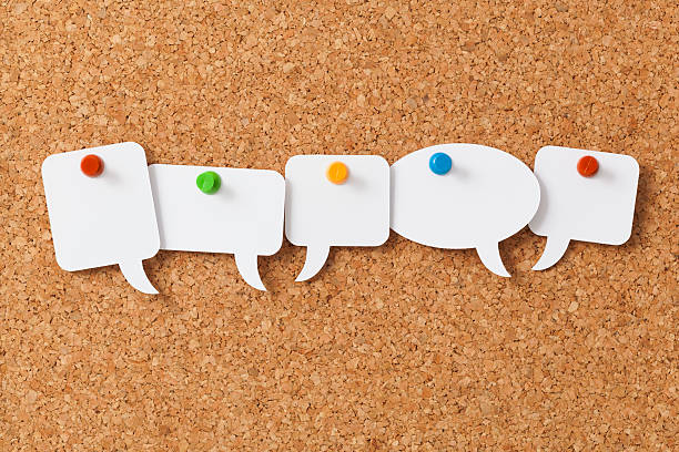 istock Five blank white speech bubbles pinned to a notice board 180752419