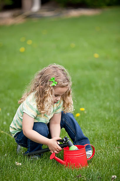 istock Girl Filling Watering Can 180753251