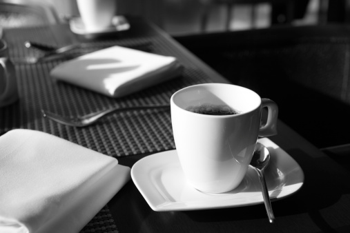 Close-up of a cup of coffee on a dining table during breakfast.