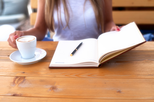 Girl drinking coffee and reading book