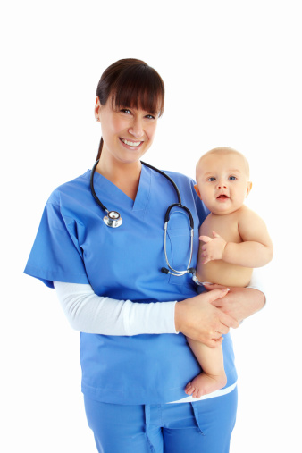 Smiling pediatrician holding a cute baby boy against a white background