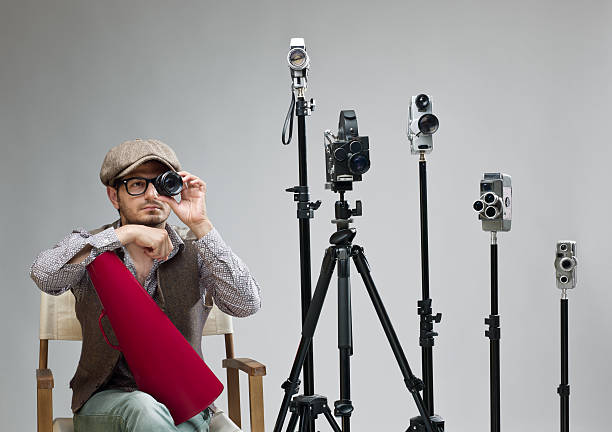 istock Film director behind camera holding lens for testing 180755122