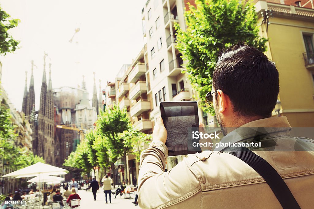 Man Taking Pictures with Tablet Man who take a photo with tablet at La Sagrada Familia, Barcelona. Adult Stock Photo
