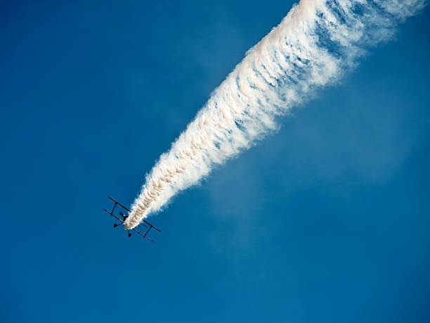 istock Aerobatic biplane flying with smoke 180755791