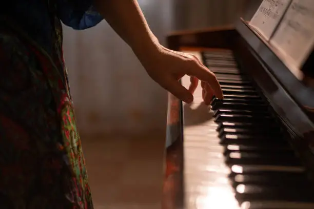 Photo of a woman plays the piano. selective focusing