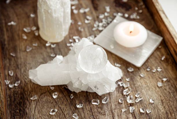 istock Gemstone sphere or crystal ball known as crystallum orbis and orbuculum which is the beacon of peace and harmony in home environment. Natural clear quartz ball on quartz geode on wood tray. 1807559091