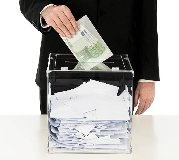 istock Introducing money in ballot box 180756116