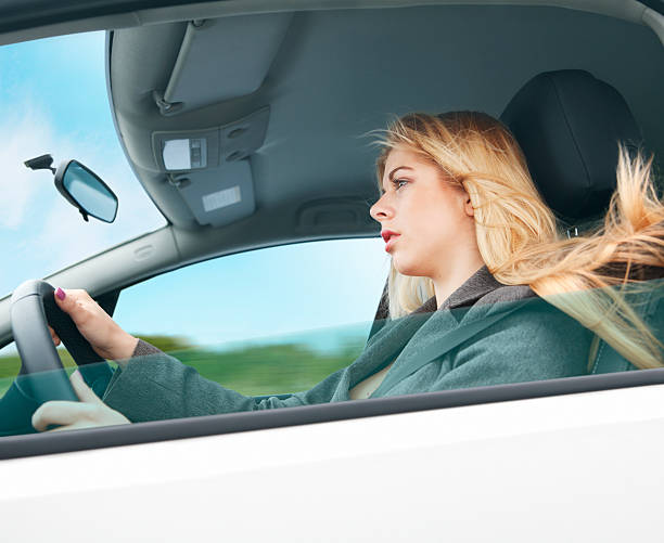 istock Young woman driving a car 180756192