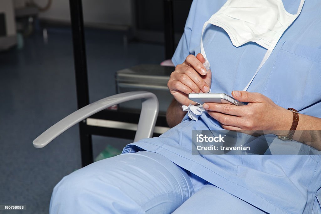 Anesthetist using smartphone Anesthetist using smartphone before operation. Adult Stock Photo