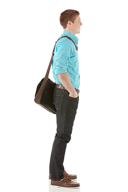 istock Profile of a man standing with hands in pockets 180758487