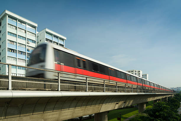 MRT Train A Mass Rapid Transit Train Traveling on elevated rail track in Yishun New Town. singapore mrt stock pictures, royalty-free photos & images