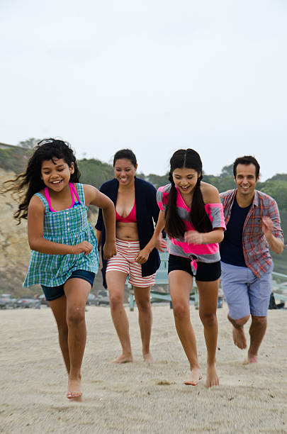 istock Happy Hispanic Family On The Beach 180759211