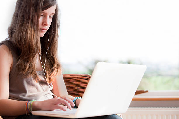 istock Teenage Girl using laptop 180759263