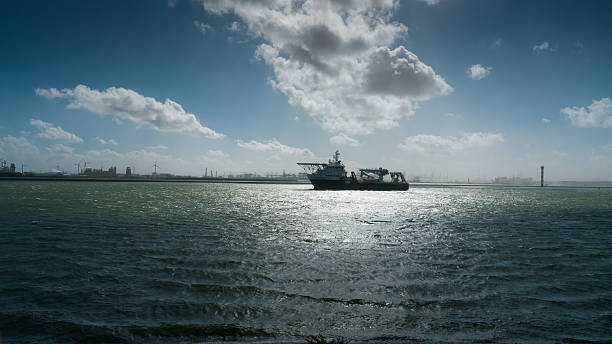 Research Vessel on the Nieuwe Waterweg entering the Rotterdam Harbor with strong wind and extreme lighting