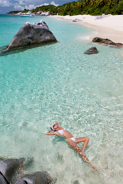 istock woman floating on crystal clear water at a Caribbean beach 180759637