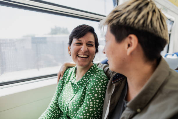 istock Lesbian couple embracing in the subway train 1807597770
