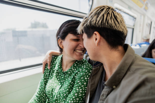 istock Lesbian couple embracing in the subway train 1807598282