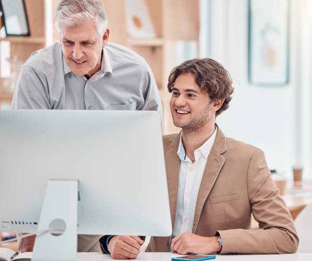 istock Senior businessman, computer and training employee in office for web design, infographics creativity and website collaboration. Teamwork, goal motivation and mentor coaching on pc planning strategy 1807598849