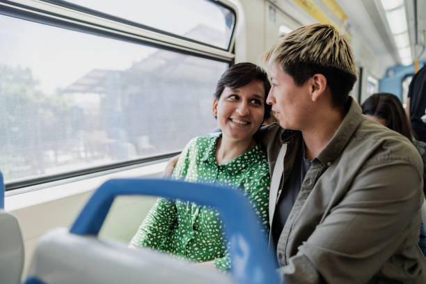 istock Lesbian couple embracing in the subway train 1807599985
