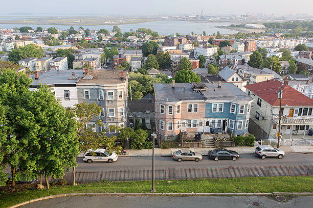 East Boston View "A view of the east Boston Neighborhood, photographed right before sunset.  Boston Logan Airport is visible in the background" east boston stock pictures, royalty-free photos & images