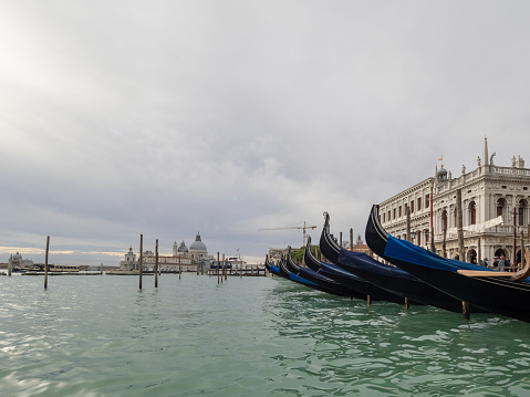 Venice, Italy - October 12th 2022: Parked gondola in Canal Grande with a sign saying Gondola Service