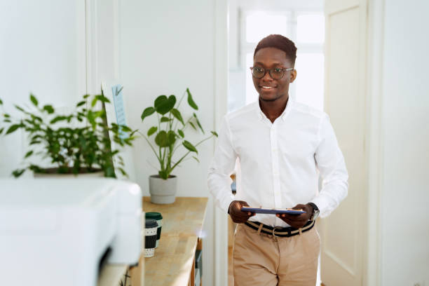 istock Well dressed young businessman working at small modern office 1807606154