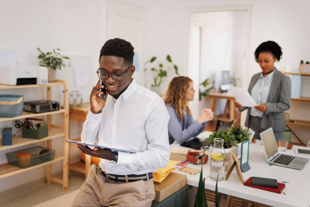 istock Young well dressed businessman using smart phone at the office 1807606718